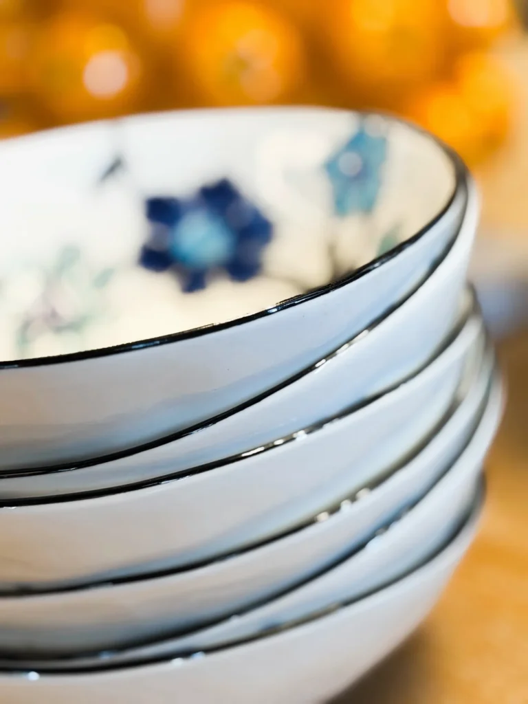Stacked white bowls with blue floral details