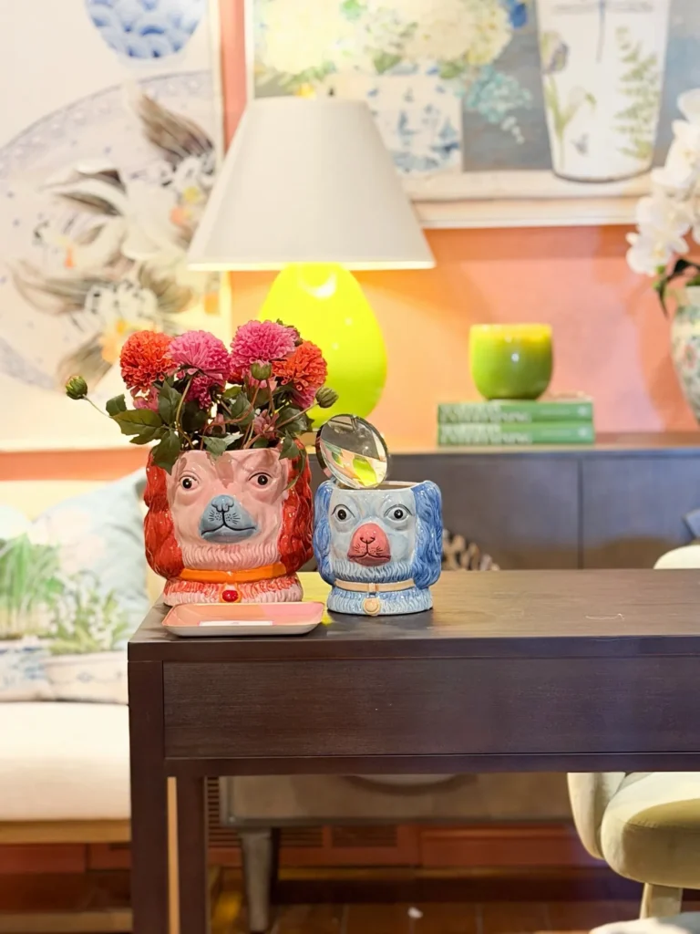 Desk styled with a lamp, fresh flowers and a colorful planter