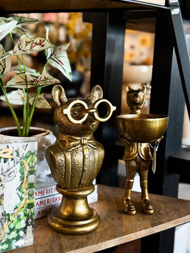 Gold owl decor pieces with a trailing plant