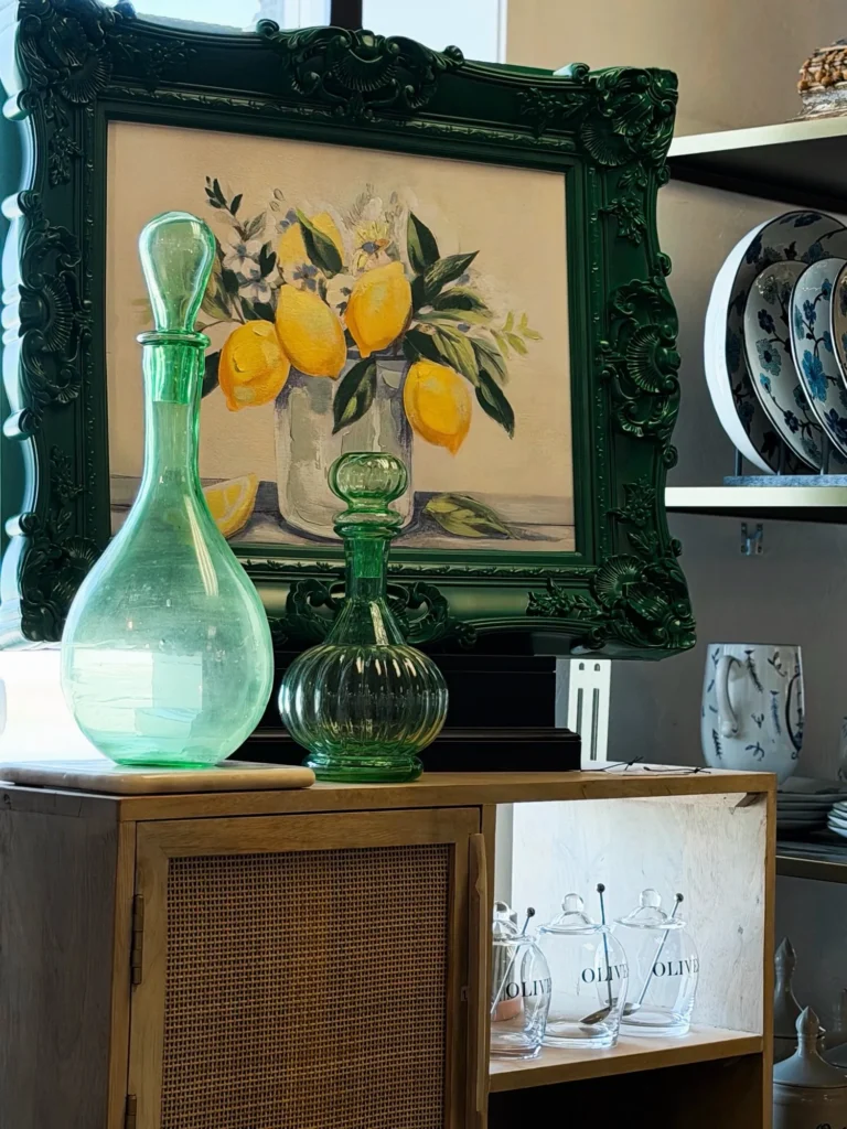 Framed lemon art with a green glass decanter