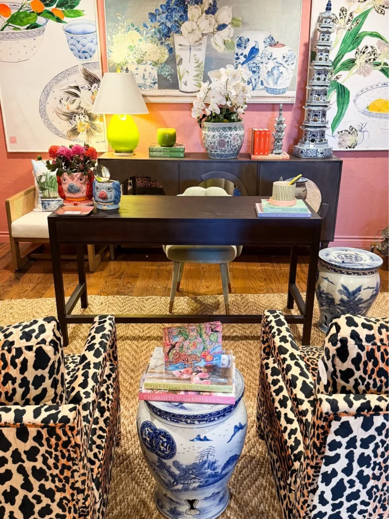 Office vignette with leopard print chairs, a dark desk and colorful art at Live Boho in Oklahoma City