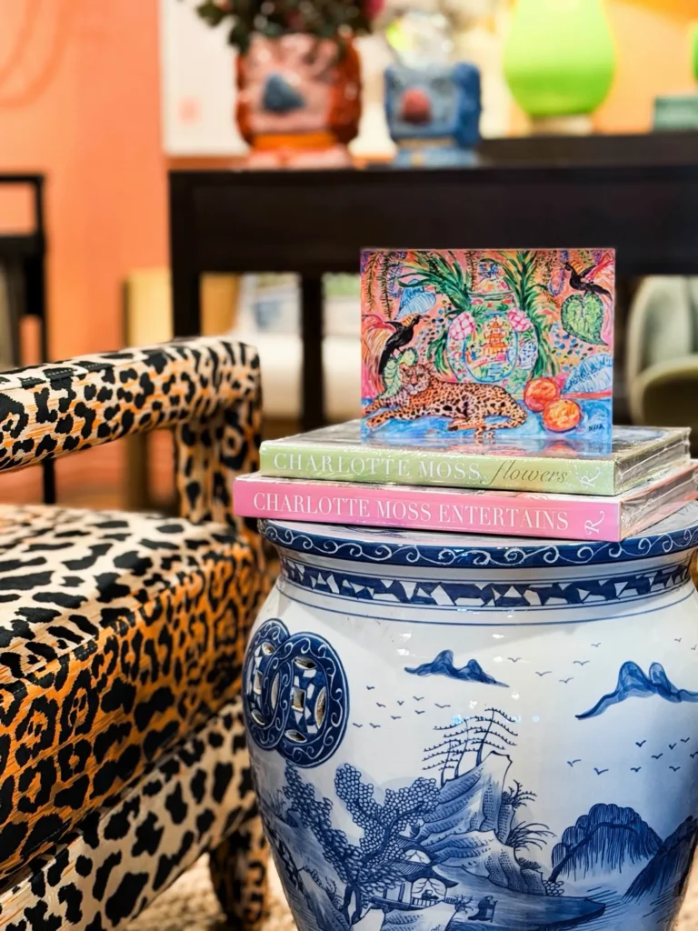 Leopard print chairs and a blue and white ginger jar in a pink-walled vignette at Live Boho