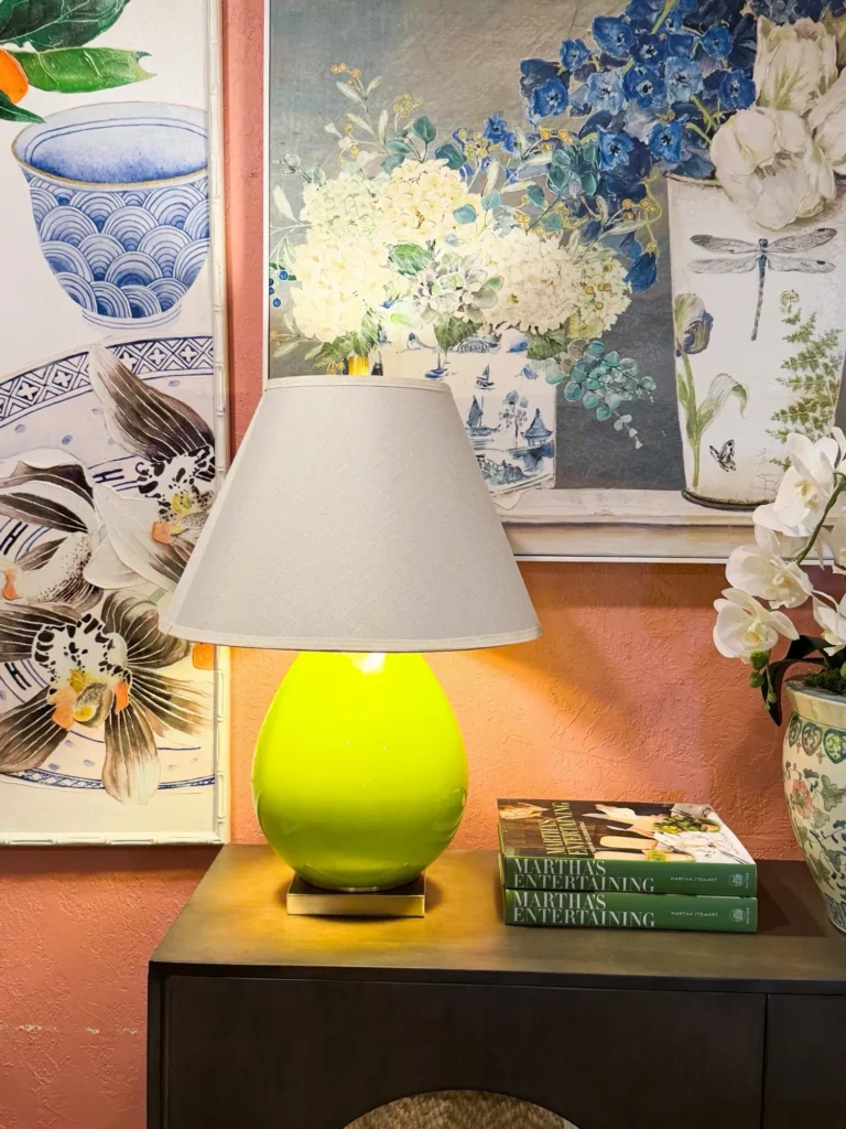 Lime green table lamp in front of blue and white floral art