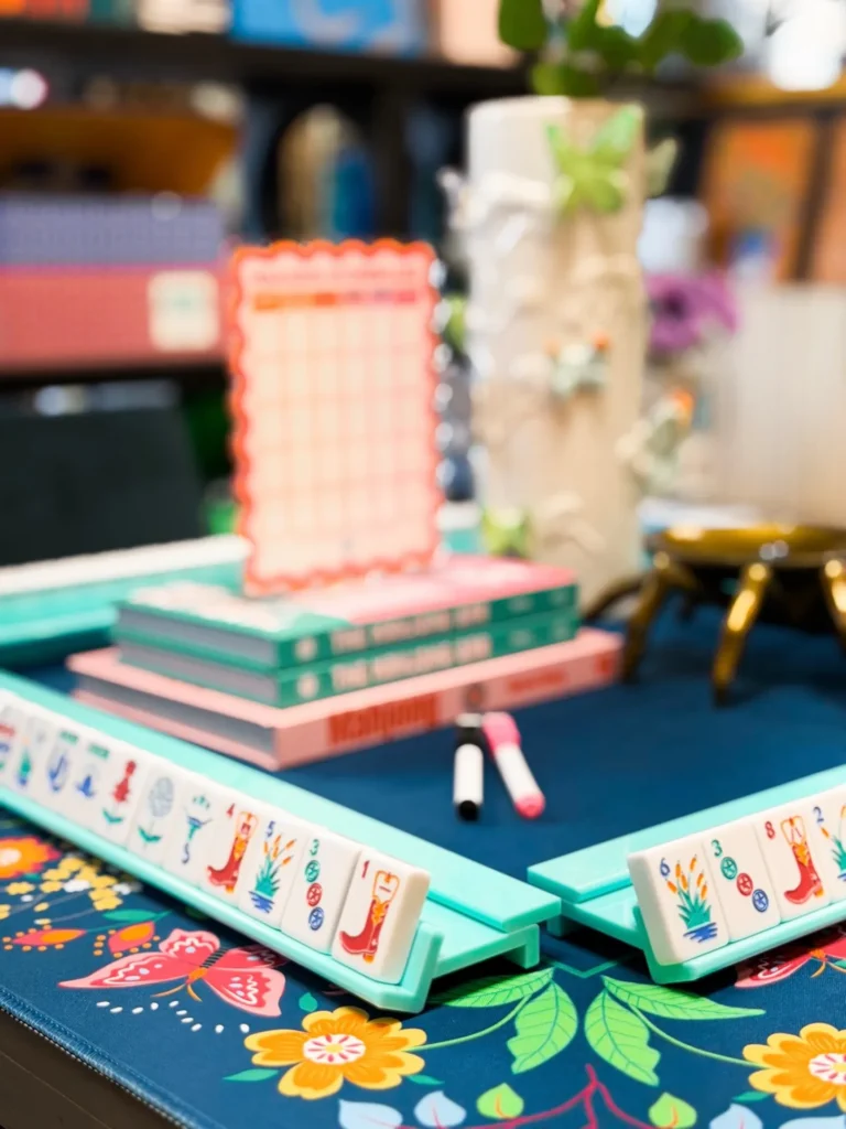 Colorful mahjong sets and accessories on a styled display table