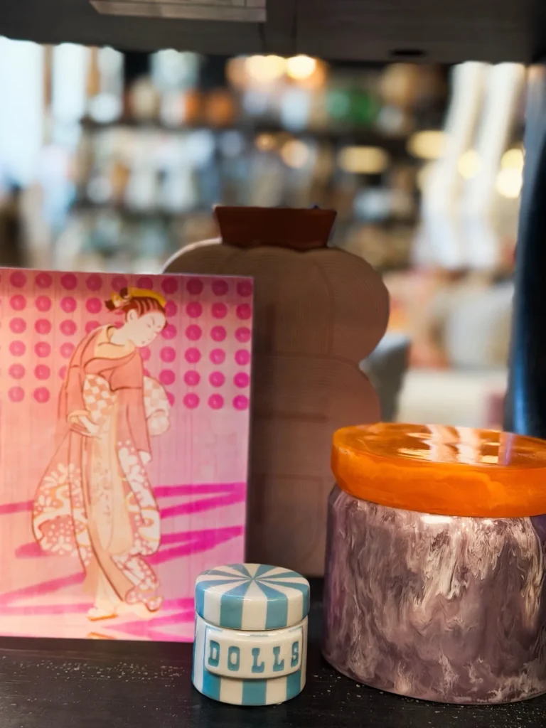 Pink art print styled with a candle and small decor