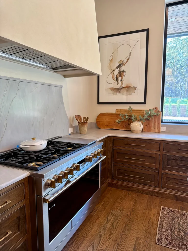 Staged kitchen with a range, wood cabinets and framed art – home staging Oklahoma City by Live Boho