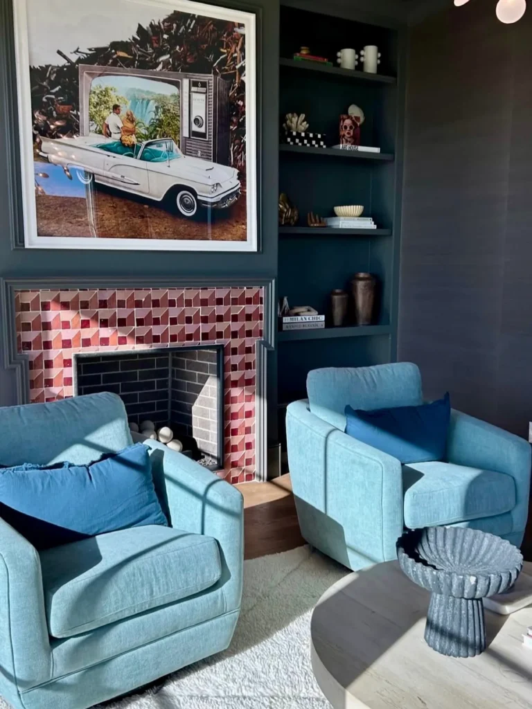 Staged sunroom with blue swivel chairs, a brick fireplace and retro car art – home staging Oklahoma City by Live Boho